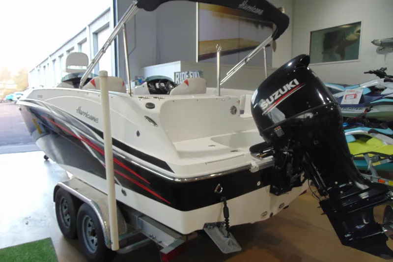 Slide: The Image of 2018 Hurricane SunDeck Sport 192 OB boat with Suzuki outboard motor in showroom. - 2