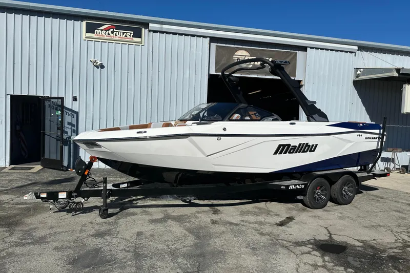 The Image of 2026 Malibu Wakesetter 23 LSV boat on trailer outside a metal building. - 0