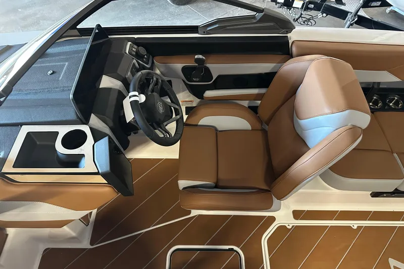 Slide: The Image of 2026 Malibu Wakesetter 23 LSV interior with brown leather seats and modern dashboard. - 11