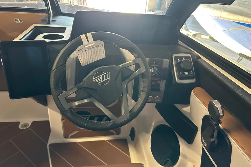 Slide: The Image of 2026 Malibu Wakesetter 23 LSV dashboard with steering wheel and control panel. - 13