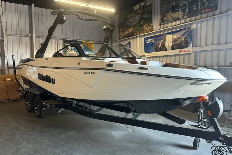 Slide: The Image of 2026 Malibu Wakesetter 23 LSV boat in showroom, sleek design, on trailer. - 19