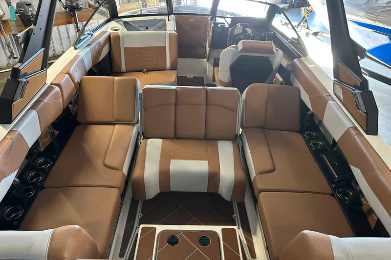 Slide: The Image of Luxurious interior of 2026 Malibu Wakesetter 23 LSV boat with brown and white seating. - 7