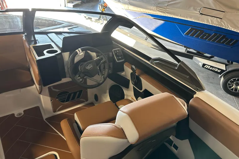 Slide: The Image of 2026 Malibu Wakesetter 23 LSV interior with brown seating and modern dashboard design. - 9