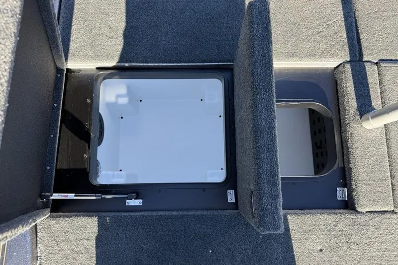 Slide: The Image of Open storage compartments on a 2026 Skeeter ZXE20 boat deck. - 27