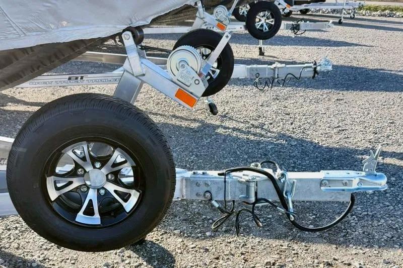 Slide: The Image of Trailer hitch and wheel of 2026 Express XP180 on gravel surface. - 12
