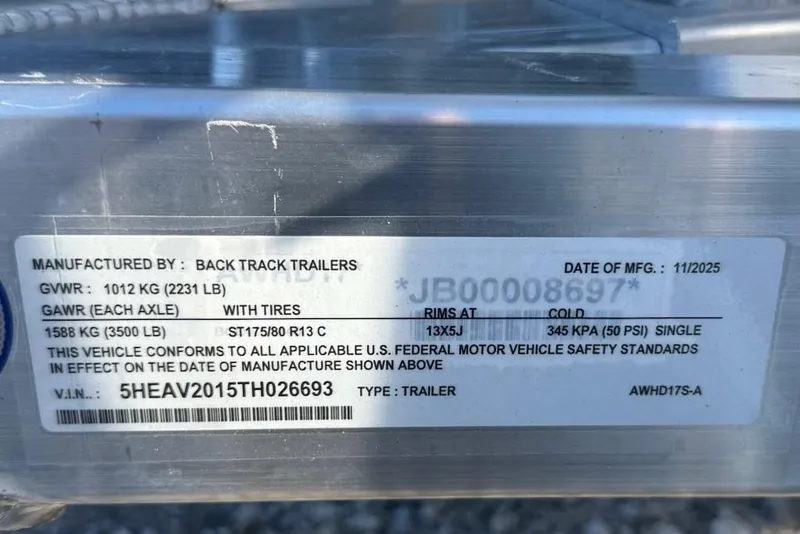 Slide: The Image of Trailer label showing specifications, including GWR, GAWR, and VIN, manufactured by Back Track Trailers. - 13