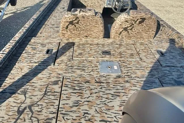 Slide: The Image of 2026 Express XP180 boat with camouflage interior design and steering console. - 2