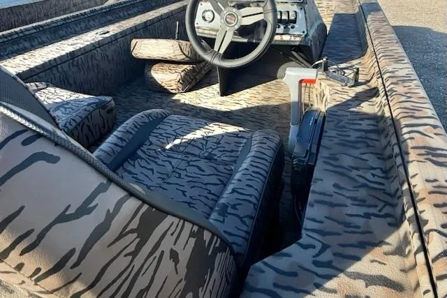Slide: The Image of 2026 Express XP180 boat interior with camouflage design and steering wheel. - 4