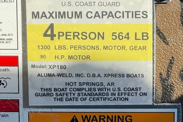 Slide: The Image of Express XP180 boat capacity label, 4 persons, 564 lbs, 90 HP motor, U.S. Coast Guard compliant. - 9