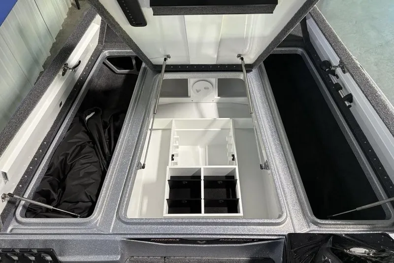 Slide: The Image of 2026 Phoenix 721 ZXL boat storage compartments with open lids and organized interior layout. - 10