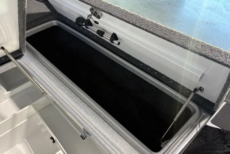 Slide: The Image of Open storage compartment in 2026 Phoenix 721 ZXL boat, showcasing interior design. - 11