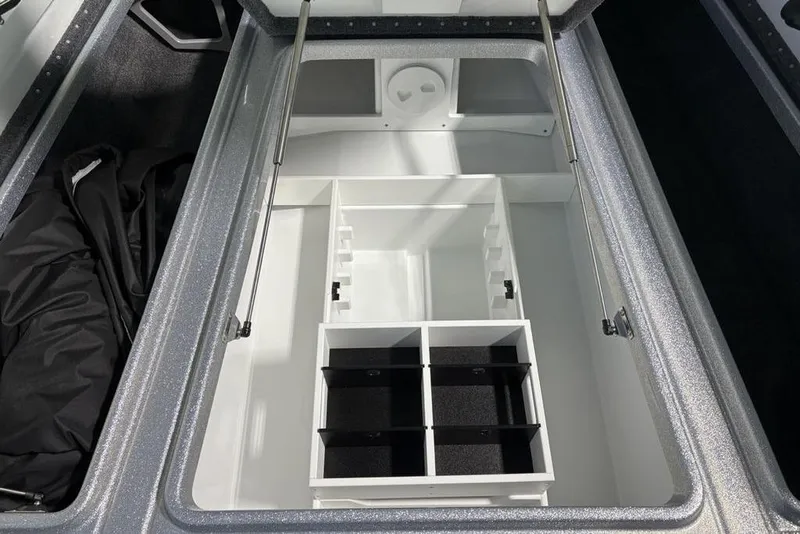 Slide: The Image of 2026 Phoenix 721 ZXL boat storage compartment with organized sections and metallic finish. - 12