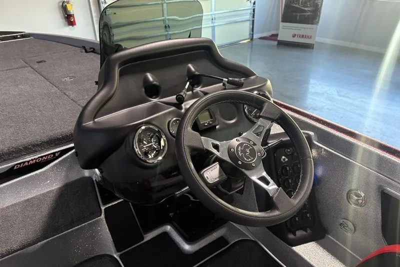 Slide: The Image of 2026 Phoenix 721 ZXL boat dashboard with steering wheel and gauges in a showroom. - 19