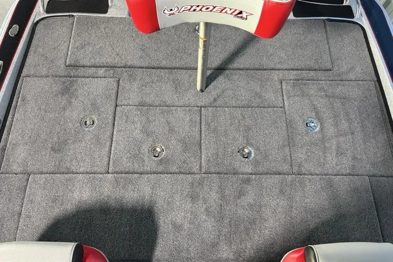 Slide: The Image of 2026 Phoenix 721 ZXL boat deck with carpeted storage compartments and branded seat. - 25