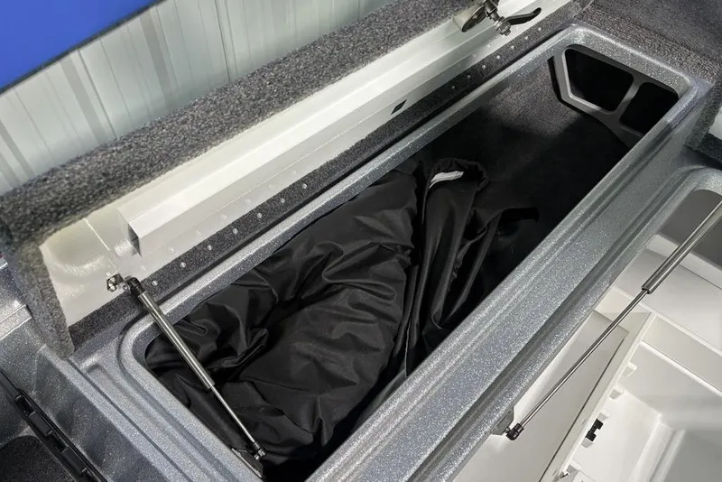 Slide: The Image of Open storage compartment in 2026 Phoenix 721 ZXL boat, featuring hydraulic lift support. - 8