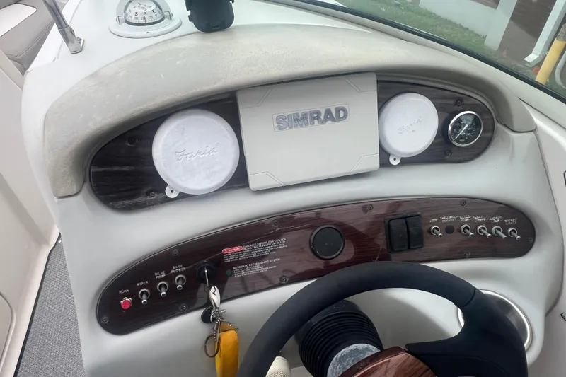 Slide: The Image of 2005 Sea Ray 270 Sundeck dashboard with Simrad navigation system and control panel. - 15