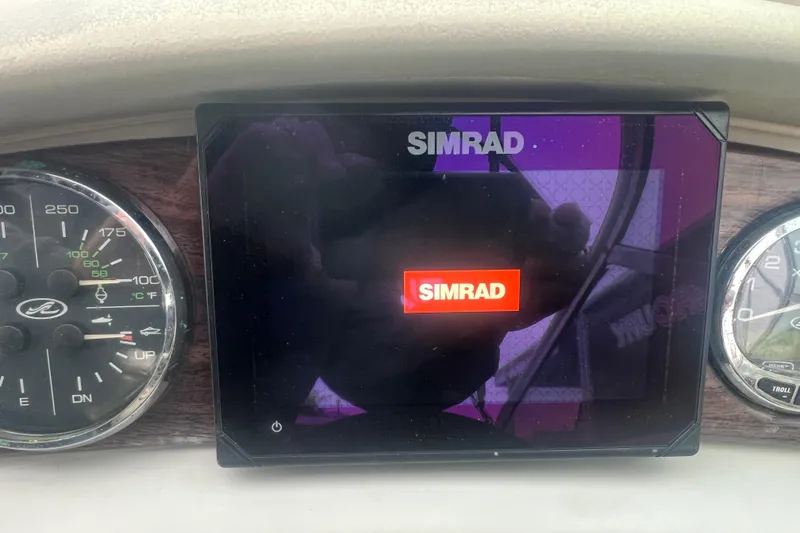 Slide: The Image of Simrad display on 2005 Sea Ray 270 Sundeck dashboard with gauges. - 17