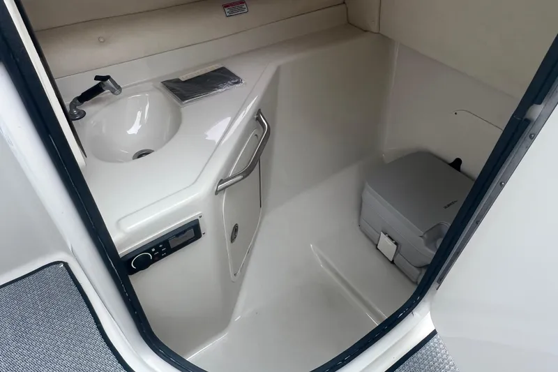 Slide: The Image of 2005 Sea Ray 270 Sundeck interior with sink and portable toilet. - 19