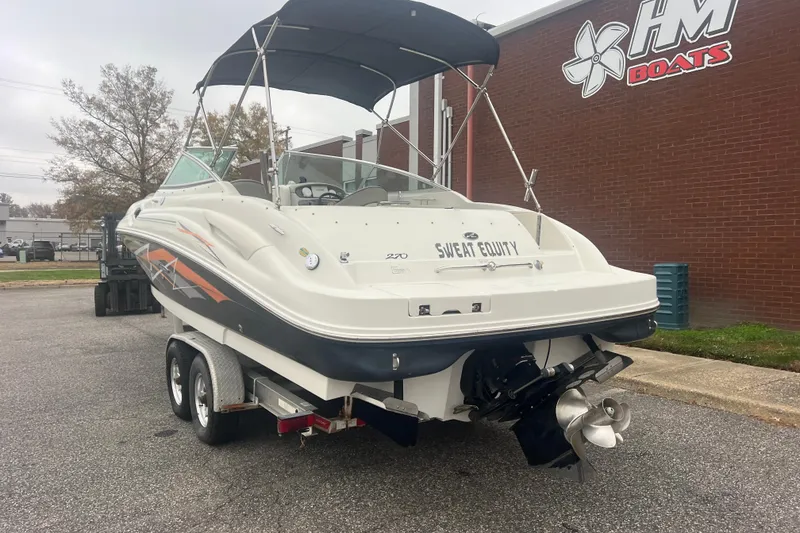 Slide: The Image of 2005 Sea Ray 270 Sundeck boat on trailer near HM Boats building. - 3