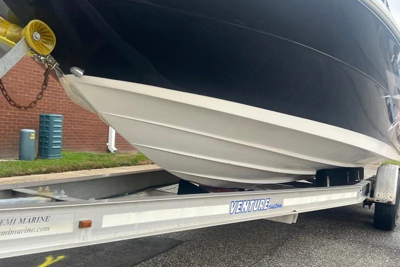 Slide: The Image of 2005 Sea Ray 270 Sundeck boat on Venture trailer, parked outdoors. - 36