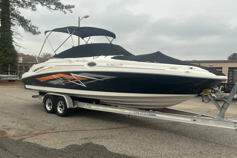 Slide: The Image of 2005 Sea Ray 270 Sundeck boat on trailer, covered and parked outdoors. - 39