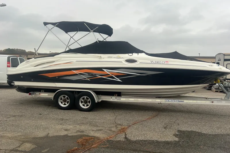 Slide: The Image of 2005 Sea Ray 270 Sundeck boat on trailer, featuring sleek design and vibrant graphics. - 40