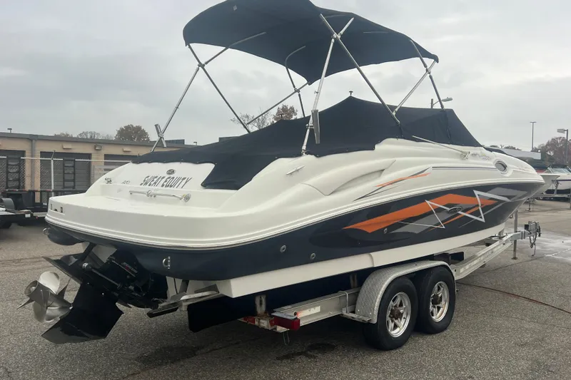 Slide: The Image of 2005 Sea Ray 270 Sundeck boat on trailer with canopy, parked outdoors. - 41