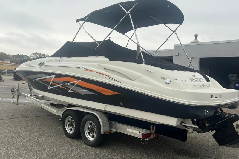 Slide: The Image of 2005 Sea Ray 270 Sundeck boat on trailer with black and orange design. - 42