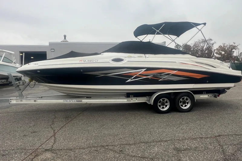 Slide: The Image of 2005 Sea Ray 270 Sundeck boat on trailer, featuring sleek design and vibrant graphics. - 43