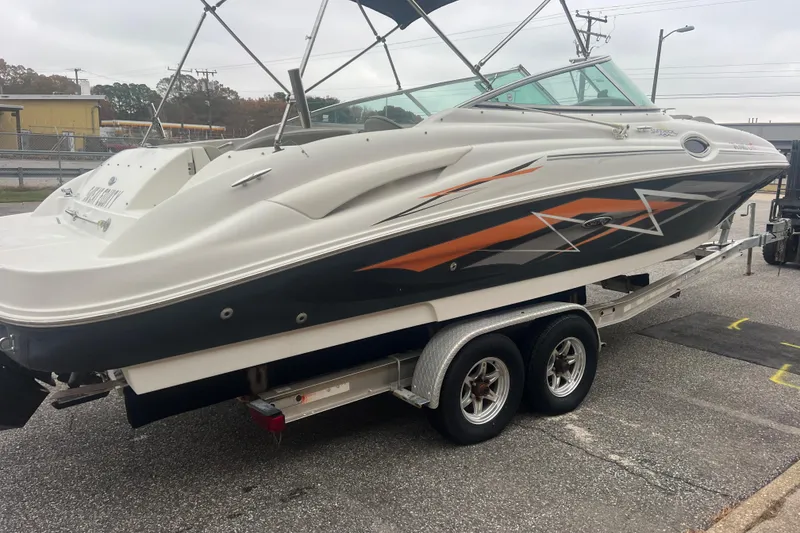 Slide: The Image of 2005 Sea Ray 270 Sundeck boat on trailer, featuring sleek design and graphics. - 6