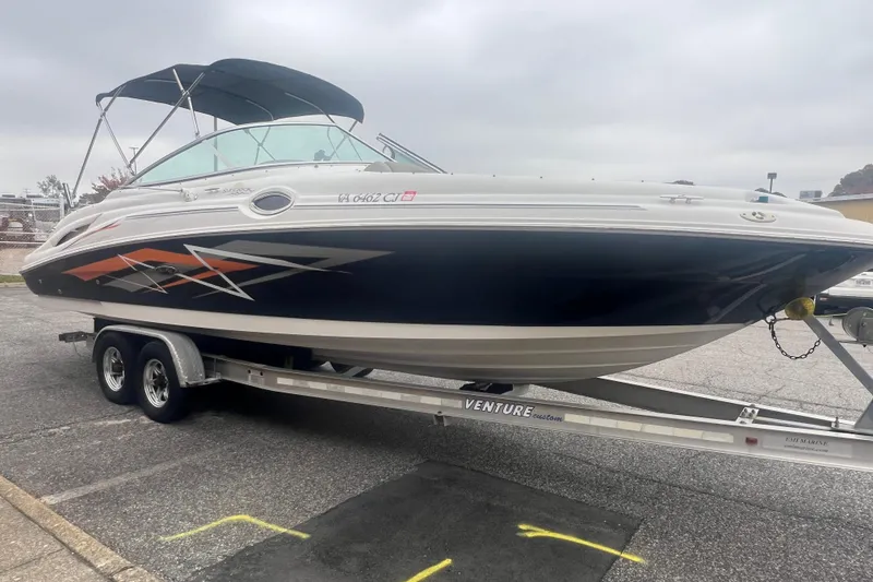 Slide: The Image of 2005 Sea Ray 270 Sundeck boat on trailer, featuring sleek design and vibrant graphics. - 7