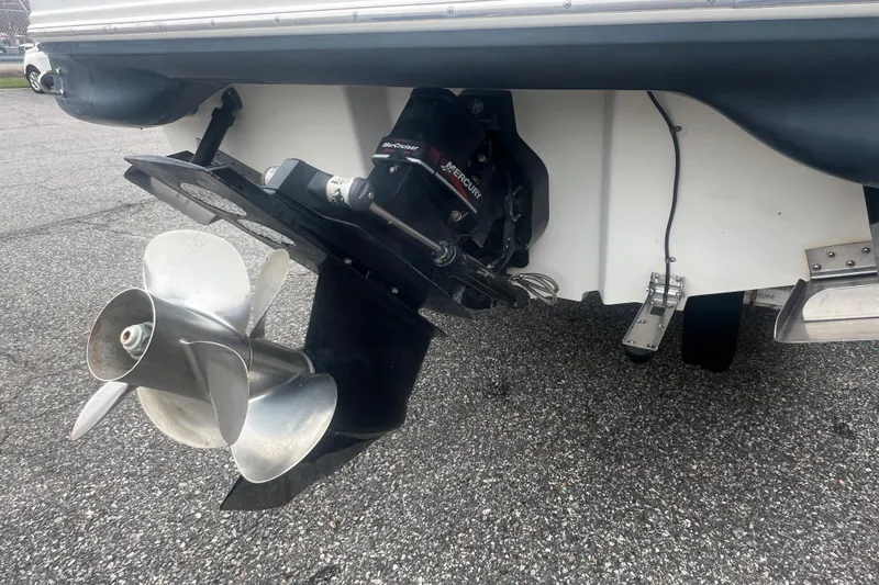 Slide: The Image of 2005 Sea Ray 270 Sundeck boat propeller and stern drive on pavement. - 9