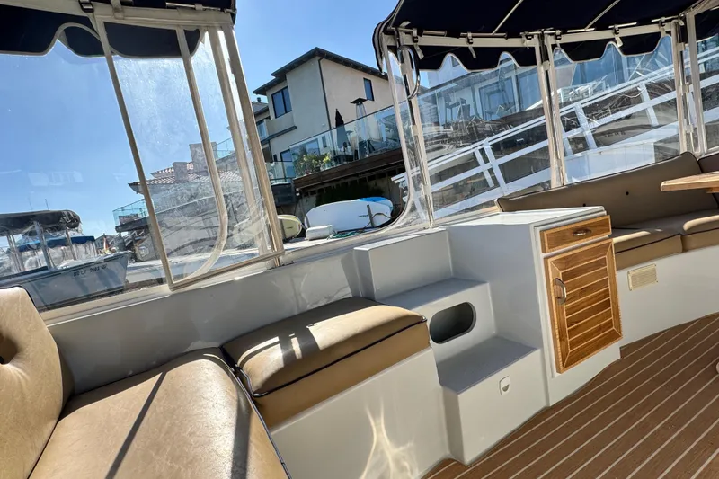 Slide: The Image of 2008 Duffy Snug Harbor boat interior with seating and wooden accents. - 12