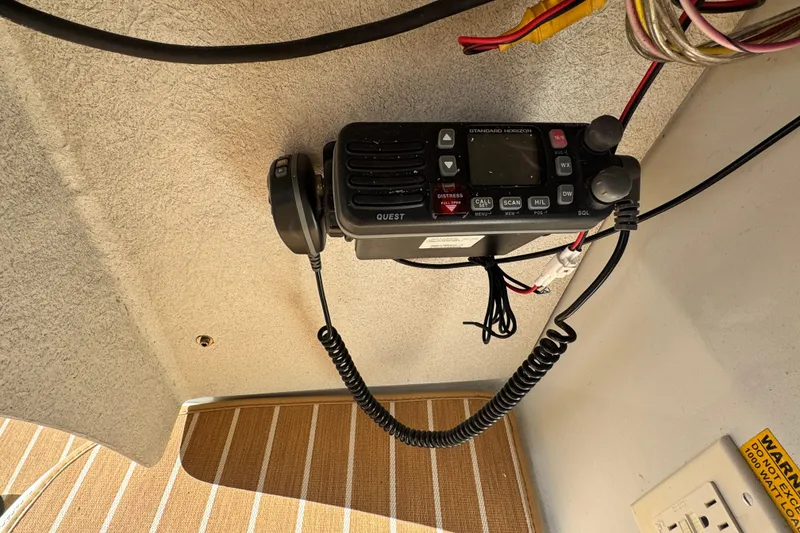Slide: The Image of Boat radio equipment inside a 2008 Duffy Snug Harbor, featuring a Standard Horizon device. - 13