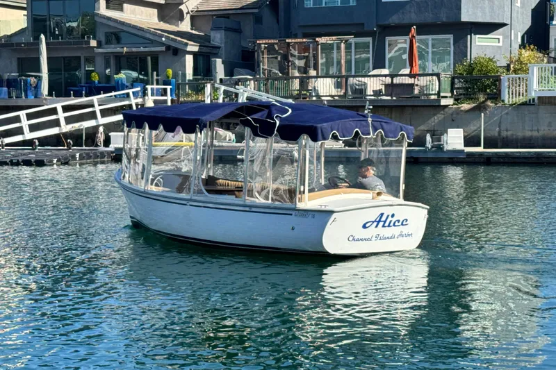 Slide: The Image of 2008 Duffy Snug Harbor boat named "Alice" cruising in a residential canal. - 4