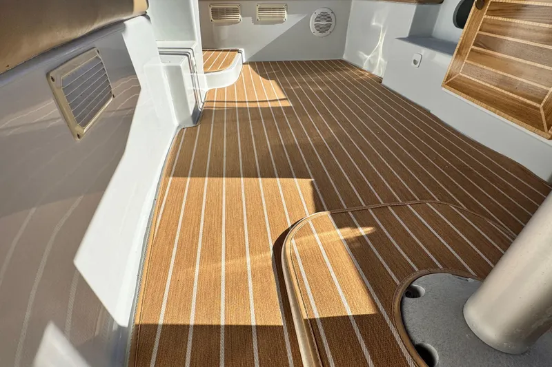 Slide: The Image of 2008 Duffy Snug Harbor boat interior with striped flooring and seating area. - 9