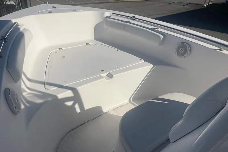 Slide: The Image of 2013 Tidewater 216 CC Adventure boat interior, featuring seating and storage area. - 11