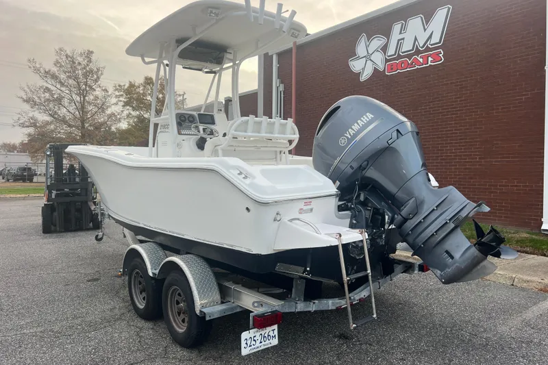Slide: The Image of 2013 Tidewater 216 CC Adventure boat with Yamaha engine on trailer, parked outside HM Boats. - 13