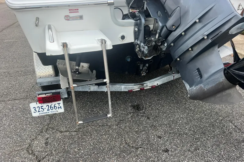 Slide: The Image of Rear view of 2013 Tidewater 216 CC Adventure boat with trailer and outboard motor. - 14