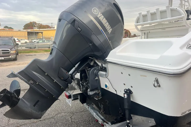 Slide: The Image of 2013 Tidewater 216 CC Adventure boat with Yamaha outboard motor, parked on a trailer. - 16