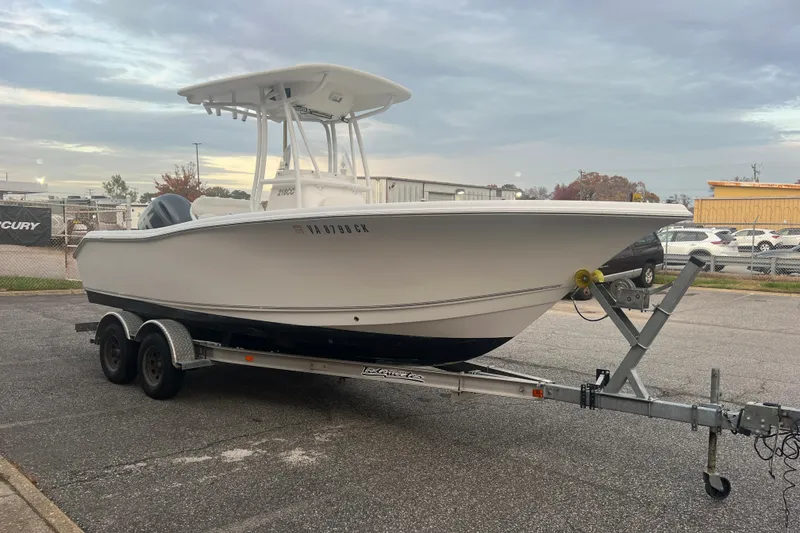 Slide: The Image of 2013 Tidewater 216 CC Adventure boat on trailer in parking lot. - 18