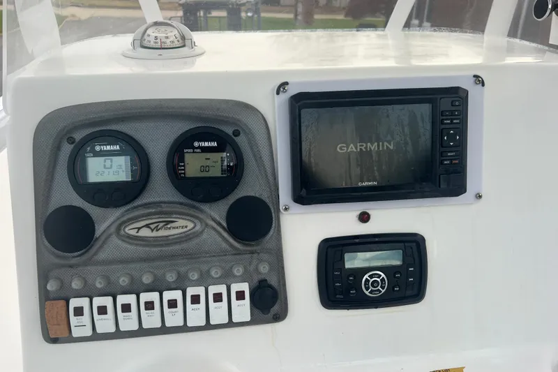 Slide: The Image of Control panel of 2013 Tidewater 216 CC Adventure boat with Garmin and Yamaha displays. - 20