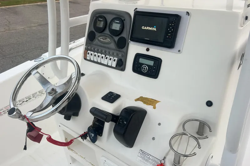 Slide: The Image of 2013 Tidewater 216 CC Adventure boat console with Garmin navigation system and controls. - 23