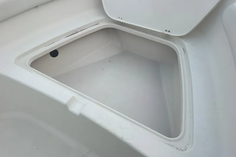 Slide: The Image of Open storage compartment on 2013 Tidewater 216 CC Adventure boat. - 26