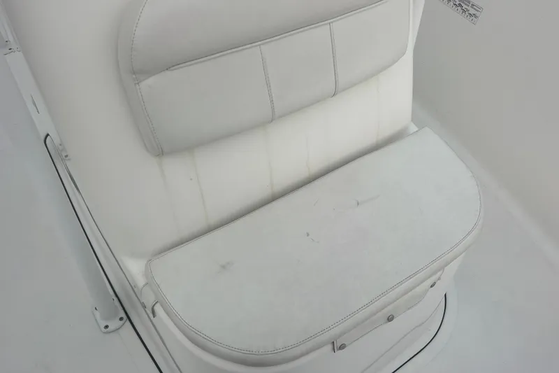 Slide: The Image of White seating on 2013 Tidewater 216 CC Adventure boat, featuring cushioned backrest and seat. - 27