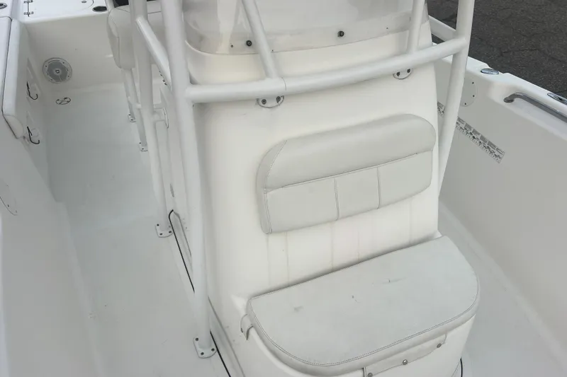 Slide: The Image of 2013 Tidewater 216 CC Adventure boat interior with white seating and console. - 30