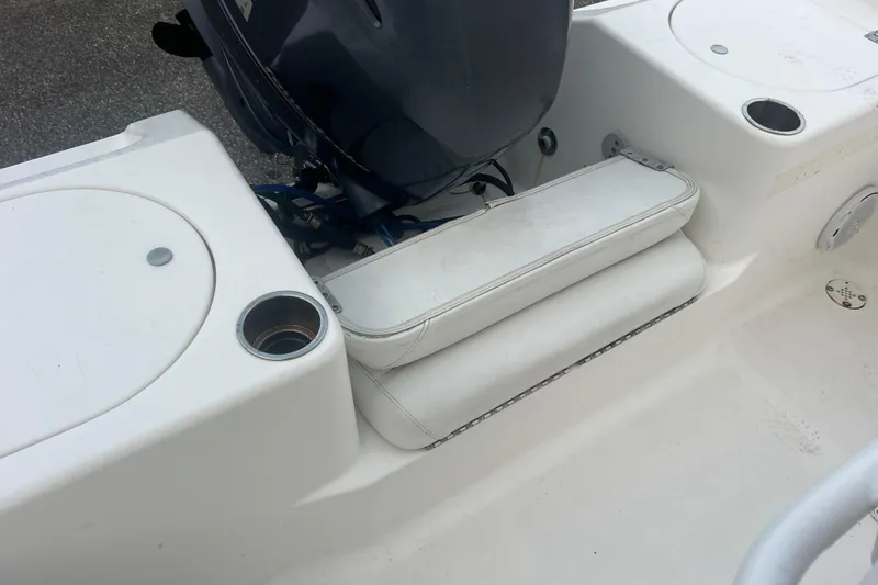 Slide: The Image of 2013 Tidewater 216 CC Adventure boat interior with seating and motor detail. - 32