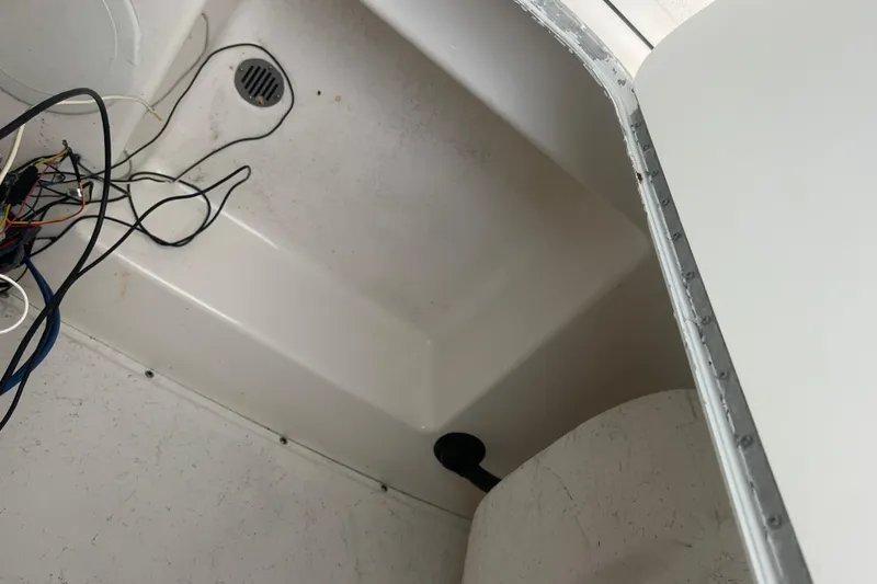 Slide: The Image of Interior view of a 2013 Tidewater 216 CC Adventure boat showing wiring and drainage. - 35