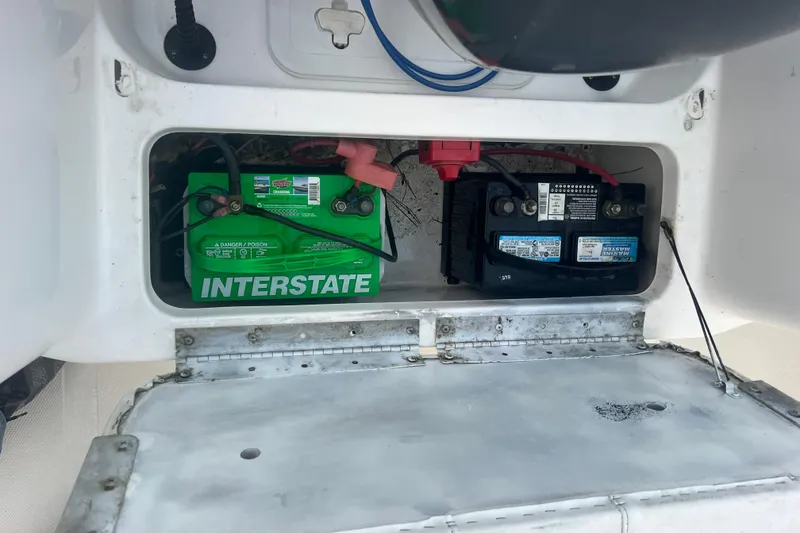 Slide: The Image of 2013 Tidewater 216 CC Adventure boat battery compartment with Interstate battery. - 38