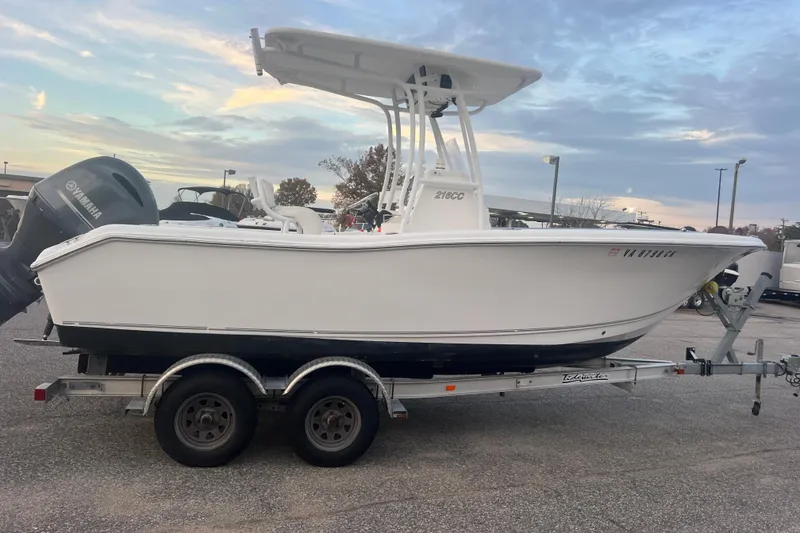 Slide: The Image of 2013 Tidewater 216 CC Adventure boat on trailer, parked outdoors at sunset. - 44